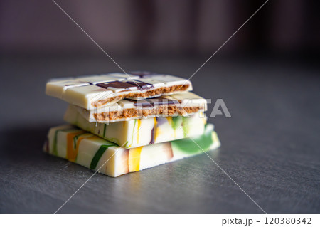 Piece of trend Dubai white chocolate with halva paste. Confectionery handmade sweets at home in the kitchen. Piece of trend Dubai white chocolate with halva paste. Confectionery handmade sweets at home in the kitchen. 120380342