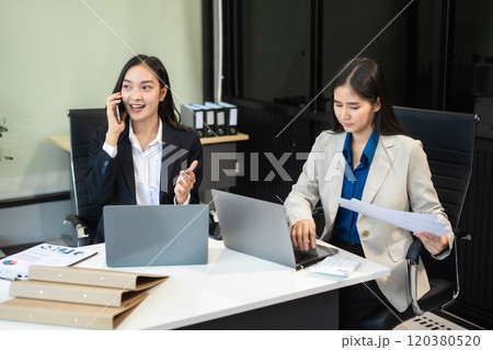 Two busy happy business woman executive leaders team using laptop working on computer. 120380520