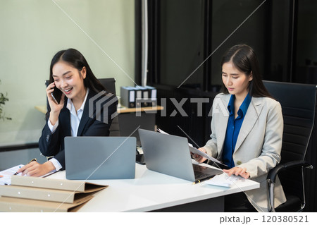 Two busy happy business woman executive leaders team using laptop working on computer. Two busy happy business woman executive leaders team using laptop working on computer. 120380521