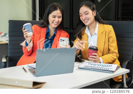 female colleague of half Asian descent holds a cup of coffee and smiles happily. female colleague of half Asian descent holds a cup of coffee and smiles happily. 120380576