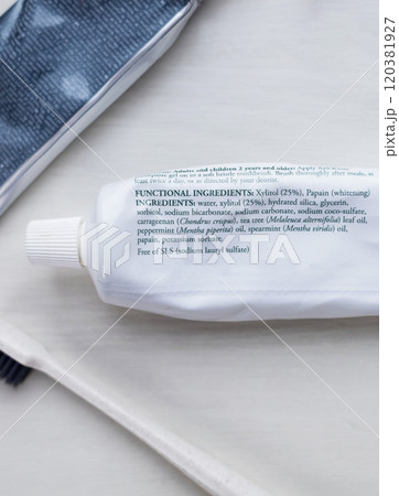 A tube of natural toothpaste with safe ingredients is lying on the table. List of natural components and ingredients. Use of ecological oral care products 120381927