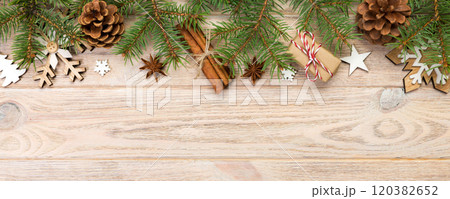 Christmas background with fir tree and gift box on wooden table. Top view with copy space for your design 120382652
