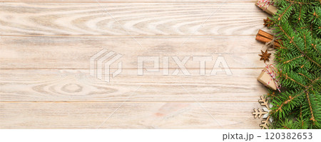 Christmas background with fir tree and gift box on wooden table. Top view with copy space for your design 120382653