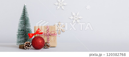 Christmas composition. Gifts, small tree, branches and craft DIY decorations on white background. New year concept. Christmas home decoration Flat lay, top view, copy space 120382768