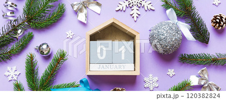 Christmas calendar 1 january. Christmas gift, fir branches, pine cones. Flat lay, top view. New Year decorations on a colored background 120382824
