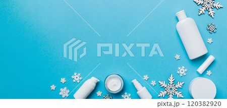 Makeup products and Christmas decorations on color background. Top view New year Beauty concept with copy space 120382920