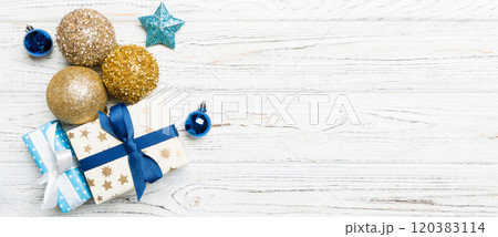 Top view Christmas ball, gift and creative decorations on wooden background. New Year holiday concept with copy space Top view Christmas ball, gift and creative decorations on wooden background. New Year holiday concept with copy space 120383114