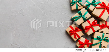wrapped christmas or other holiday handmade present in paper with colored ribbon. Present box, decoration of gift on colourfull table, top view with copy space wrapped christmas or other holiday handmade present in paper with colored ribbon. Present box, decoration of gift on colourfull table, top view with copy space 120383146