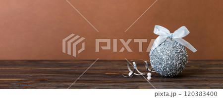 Christmas ball on colored background. decoration bauble with ribbon bow with copy space Christmas ball on colored background. decoration bauble with ribbon bow with copy space 120383400