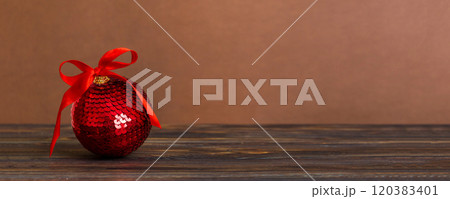 Christmas ball on colored background. decoration bauble with ribbon bow with copy space Christmas ball on colored background. decoration bauble with ribbon bow with copy space 120383401