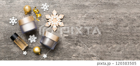 Makeup products and Christmas decorations on color background. Top view New year Beauty concept Makeup products and Christmas decorations on color background. Top view New year Beauty concept 120383505