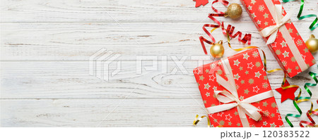 Holiday flat lay with gift boxes wrapped in colorful paper and tied decorated with confetti on colored background. Christmas, Birthday, Valentine and sale concept, top view Holiday flat lay with gift boxes wrapped in colorful paper and tied decorated with confetti on colored background. Christmas, Birthday, Valentine and sale concept, top view 120383522