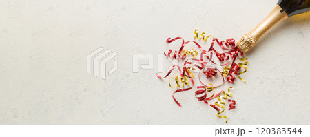 Creative flat lay composition with bottle of champagne and space for text on color background. Champagne bottle with colorful party streamers. holiday or christmas concept 120383544
