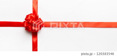 Top view of Red ribbon rolled and red bow isolated on colored background. Flat lay with copy space 120383546