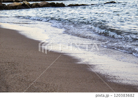 The beach with sea waves running on the sand. Beautiful view on the waves 120383682