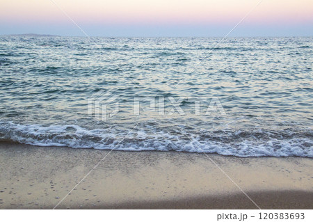 The beach with sea waves running on the sand. Beautiful view on the waves 120383693