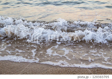 The beach with sea waves running on the sand. Beautiful view on the waves 120383705