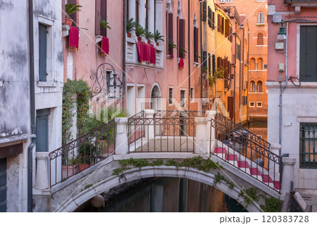 Venice, Italy street, canal and small bridge 120383728