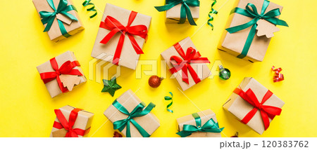 Colored craft gift boxes with colorful ribbons on colored background. Collection of Christmas present boxes Colored craft gift boxes with colorful ribbons on colored background. Collection of Christmas present boxes 120383762