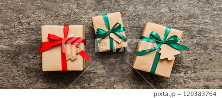 Colored craft gift boxes with colorful ribbons on colored background. Collection of Christmas present boxes 120383764