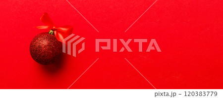 Christmas ball on colored background. decoration bauble with ribbon bow with copy space Christmas ball on colored background. decoration bauble with ribbon bow with copy space 120383779