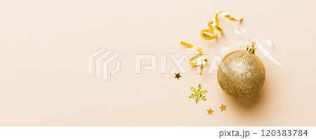 Christmas ball on colored background. decoration bauble with ribbon bow with copy space Christmas ball on colored background. decoration bauble with ribbon bow with copy space 120383784