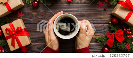 Woman holding cup of coffee. Woman hands holding a mug with hot coffee. Winter and Christmas time concept Woman holding cup of coffee. Woman hands holding a mug with hot coffee. Winter and Christmas time concept 120383797