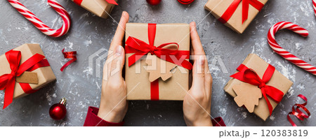 Woman hands holding gift box, preparing surprise for holiday, top view, Christmas and New Year concept 120383819