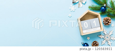 Christmas calendar 1 january. Christmas gift, fir branches, pine cones. Flat lay, top view. New Year decorations on a colored background Christmas calendar 1 january. Christmas gift, fir branches, pine cones. Flat lay, top view. New Year decorations on a colored background 120383911