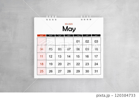 May 2025 desk calendar on gray cement wall background. 120384733