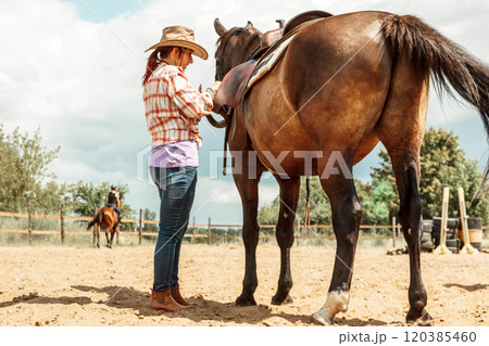 Western cowgirl woman with horse. Sport activity 120385460