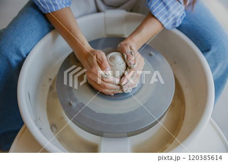 Discover the intricate art of Artisan Pottery Making on a Wheel and its beautiful techniques 120385614