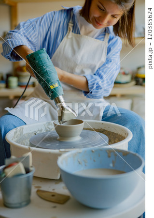 Creating beautiful pottery in a sunny studio filled with creativity, inspiration, and joy Creating beautiful pottery in a sunny studio filled with creativity, inspiration, and joy 120385624