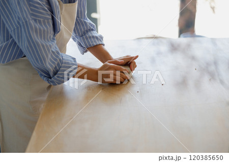 Artisan Craftsman Skillfully Kneading Fresh Dough on a Rustic Wooden Surface with Care Artisan Craftsman Skillfully Kneading Fresh Dough on a Rustic Wooden Surface with Care 120385650