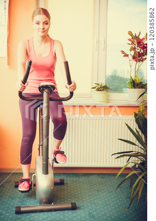 Woman working out on exercise bike. Fitness. 120385862