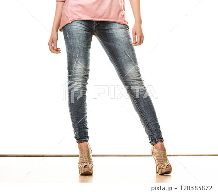 woman legs in denim trousers high heels shoes 120385872