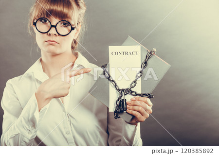 woman holding in hands contract and chain with padlock 120385892