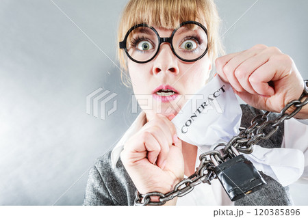 Furious woman with chained hands and contract 120385896