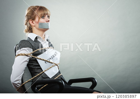 Woman bound by contract terms with taped mouth. 120385897