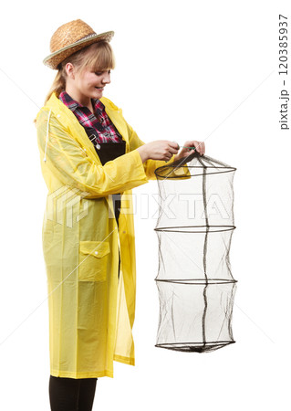 Happy woman holding empty fishing keepnet Happy woman holding empty fishing keepnet 120385937