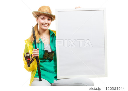Happy woman with fishing rod holding board Happy woman with fishing rod holding board 120385944