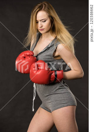 Beautiful woman with red boxing gloves 120386662