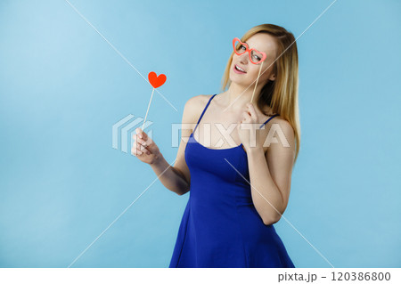 Woman holding carnival accessoies on stick 120386800