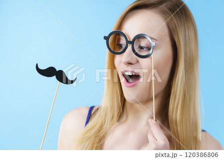 Woman holding carnival accessories on stick 120386806