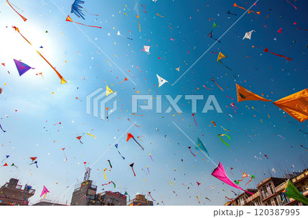 Beautiful greeting card with colorful kites soaring high above vibrant sky to holiday composition 120387995