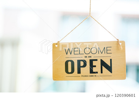 Open sign welcoming customers, symbolizing the beginning of a new business day. 120390601