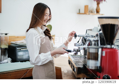 Dedicated barista preparing coffee, demonstrating professionalism and skill in a cafe setting. Dedicated barista preparing coffee, demonstrating professionalism and skill in a cafe setting. 120390619