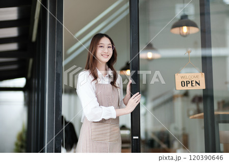 Cafe staff or owner opening the shop door, inviting customers with a friendly to start the day. Cafe staff or owner opening the shop door, inviting customers with a friendly to start the day. 120390646
