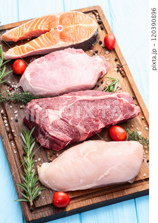 Mix of raw meat and fish . Salmon , beef , pork , chicken staek . Top view 120390896