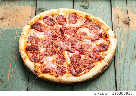 Pizza pepperoni fast food . Top view on rustic background 120390910